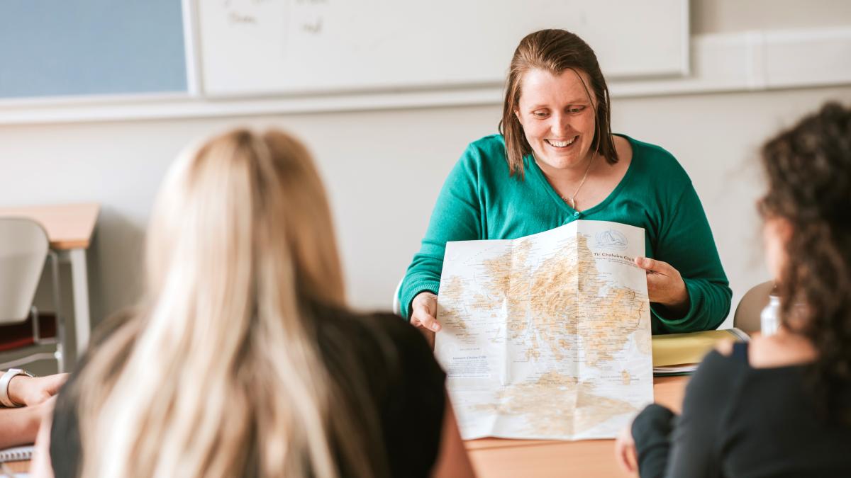 Tutor using a map in Gaelic class.