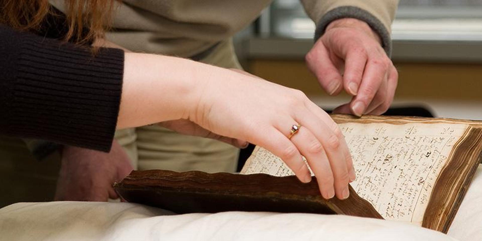 person reading a book in special collections