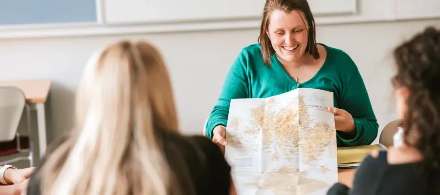 Tutor using a map in Gaelic class.