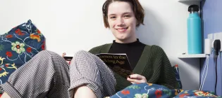 Person sitting on a bed
