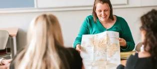 Tutor using a map in Gaelic class.