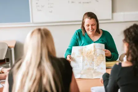 Tutor using a map in Gaelic class.