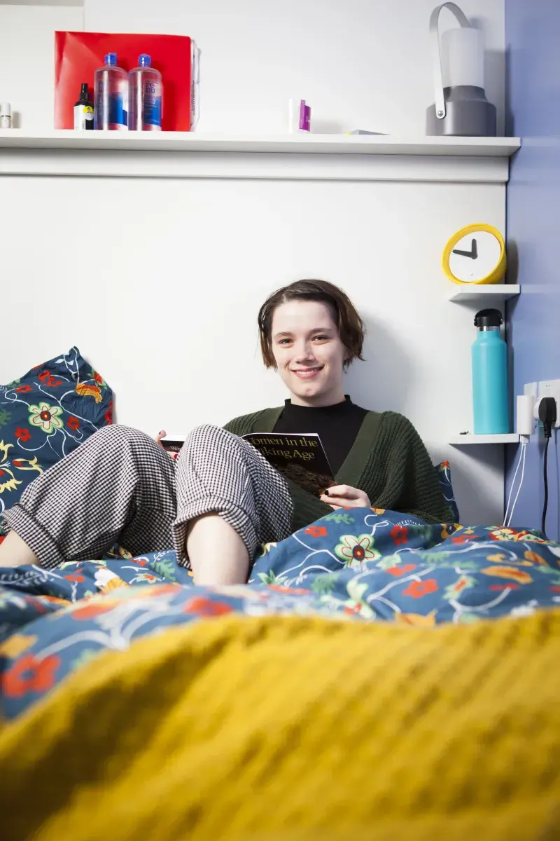 Person sitting on a bed