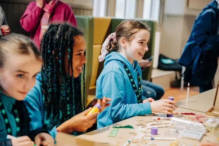 Children sitting around a table doing crafts