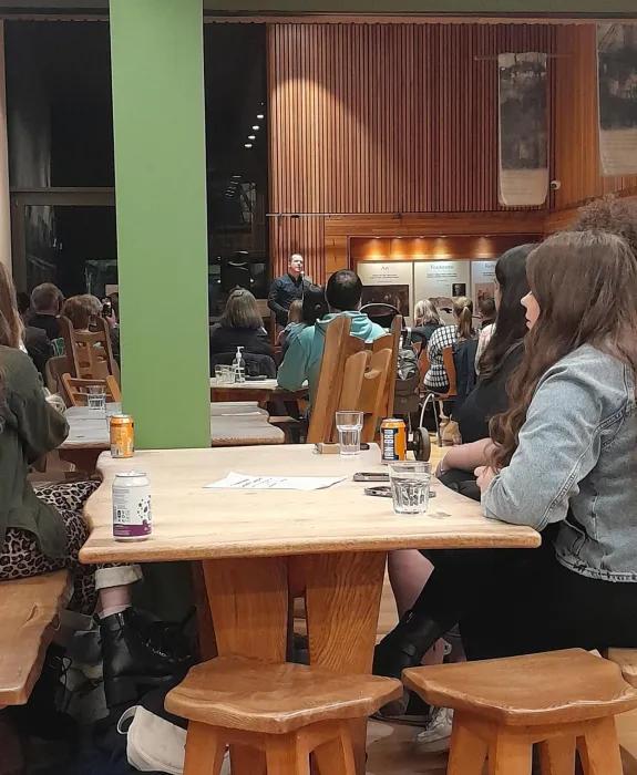 Students watch musicians in Scottish Storytelling Centre. 
