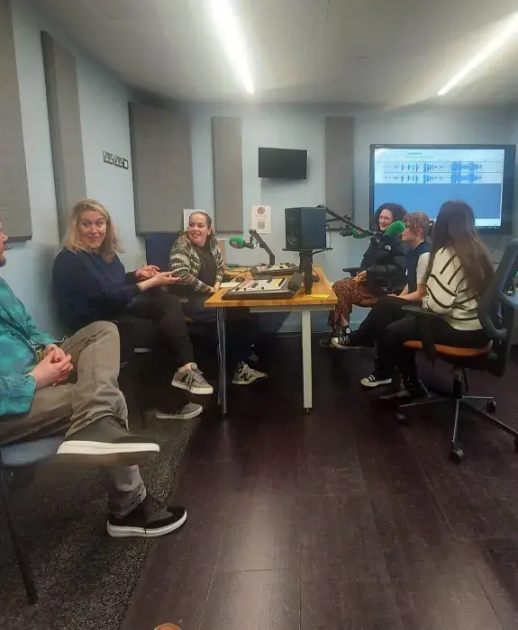 Students in radio studio. 